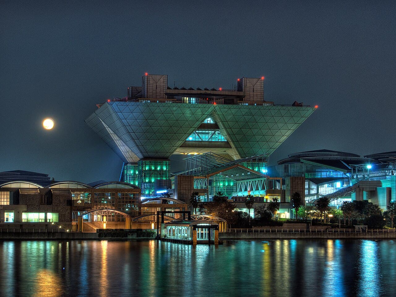 Tokyo Big Sight's iconic inverted-pyramid towers lit up at night — the venue of Comic Market (Comiket) 109.