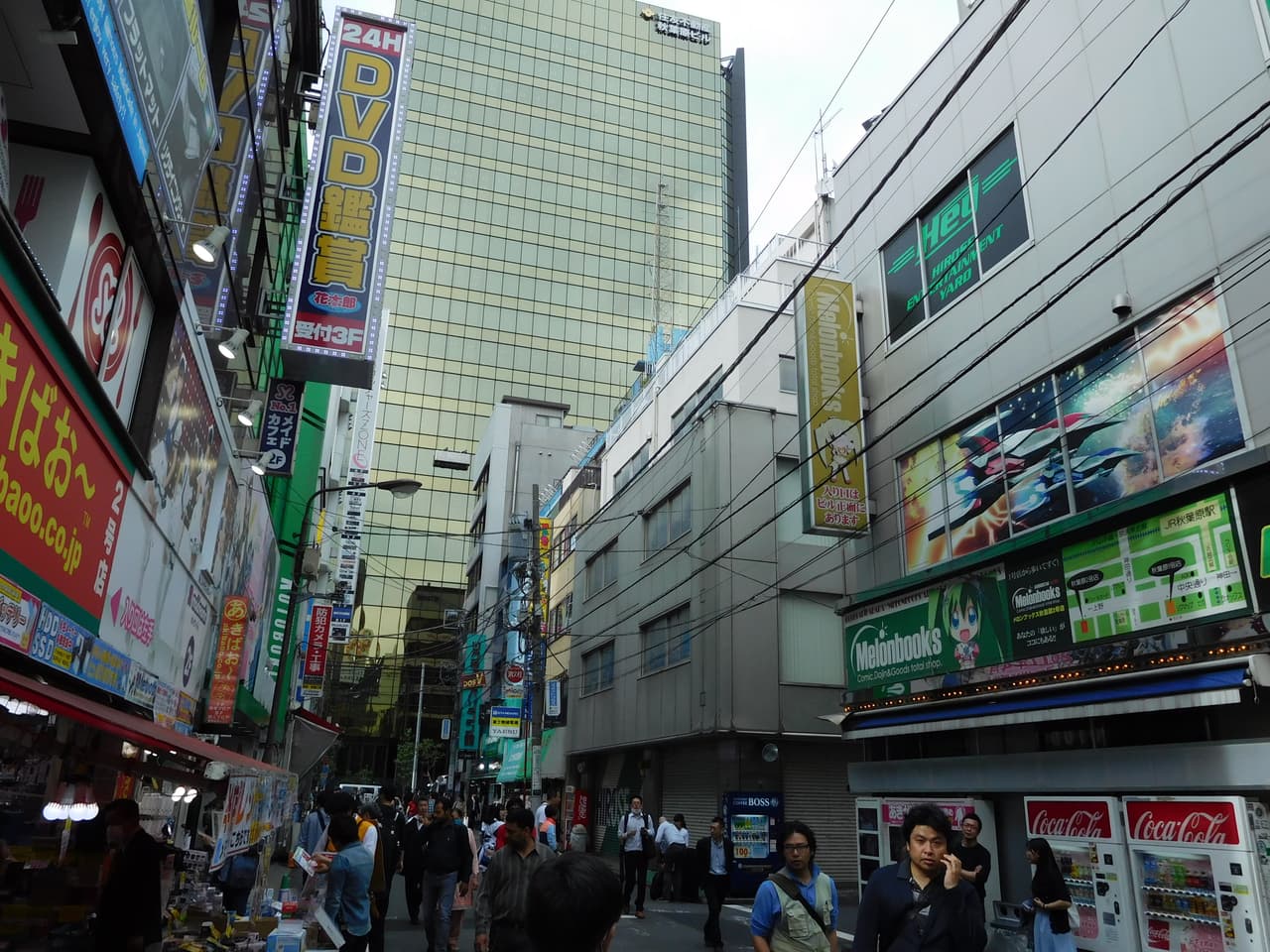 Street view of Akihabara's Chuo-dori side alley (Akiba South Ura street) with the Melonbooks Akihabara doujin/anime goods store storefront visible on the right, April 2017.