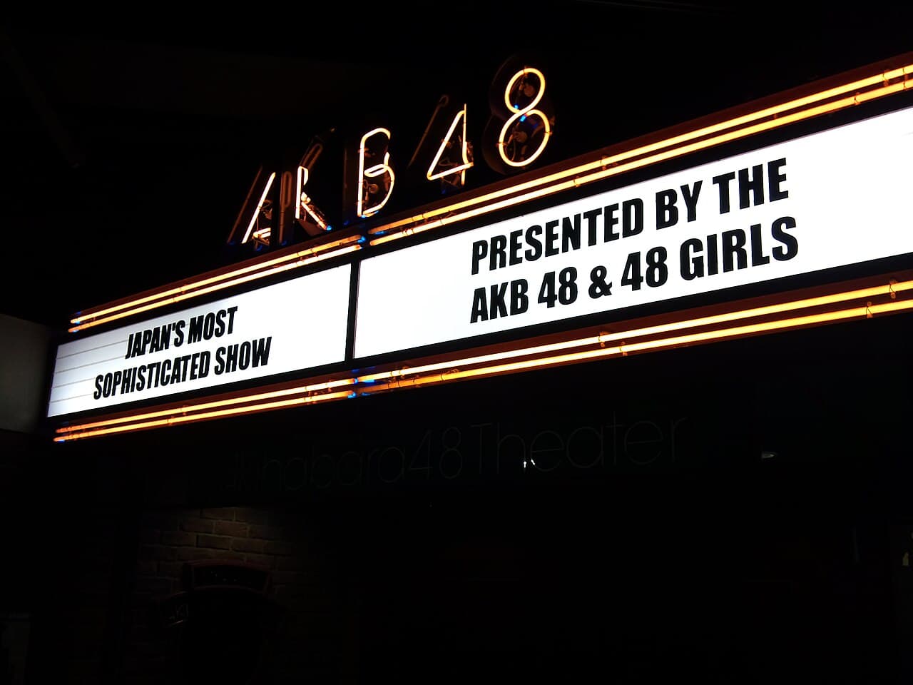 The illuminated AKB48 Theater neon sign on the Don Quijote building in Akihabara, Tokyo, lit up at night
