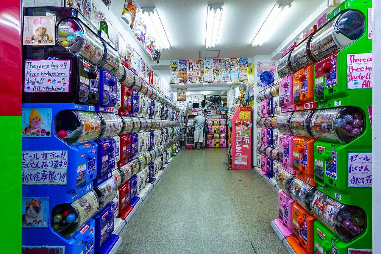 Rows of gashapon capsule-toy vending machines packed wall to wall inside a shop in Akihabara, Tokyo.